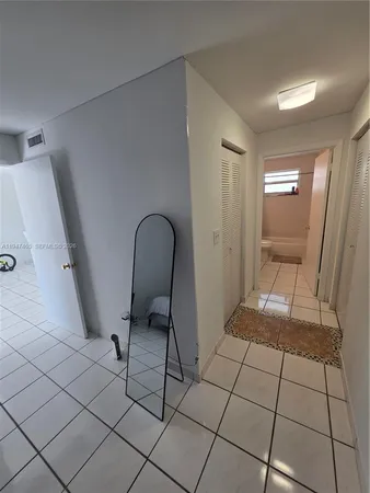 a view of bedroom with wooden floor and entryway