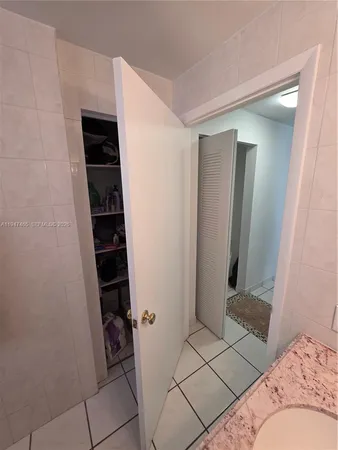 a living room with a couch and a floor to ceiling window