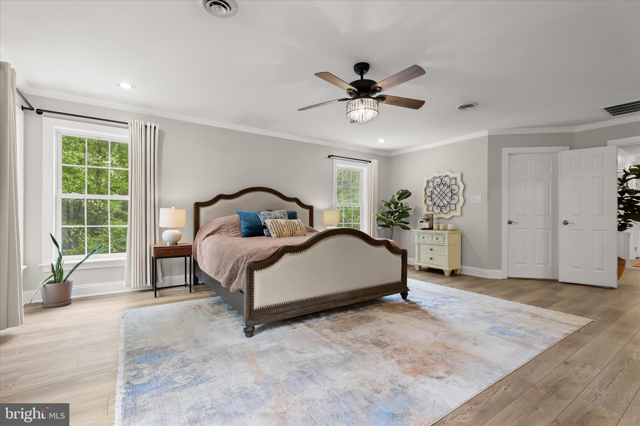 515 Garrison Forest Road Owings Mills, MD 21117 - Photo 37 of 84 a bedroom with a bed a window and a chandelier