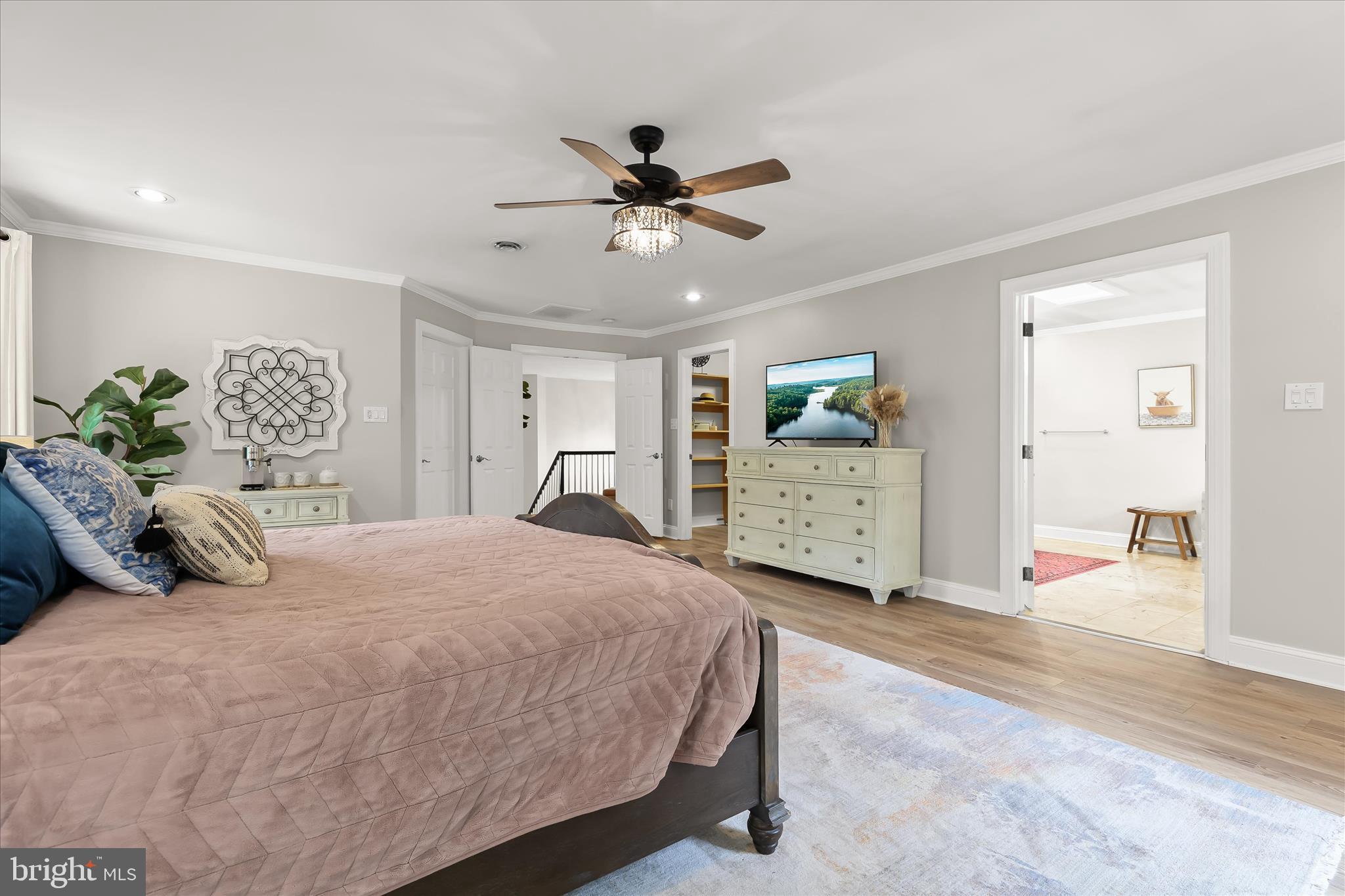 515 Garrison Forest Road Owings Mills, MD 21117 - Photo 39 of 84 a bedroom with a large bed and a chandelier