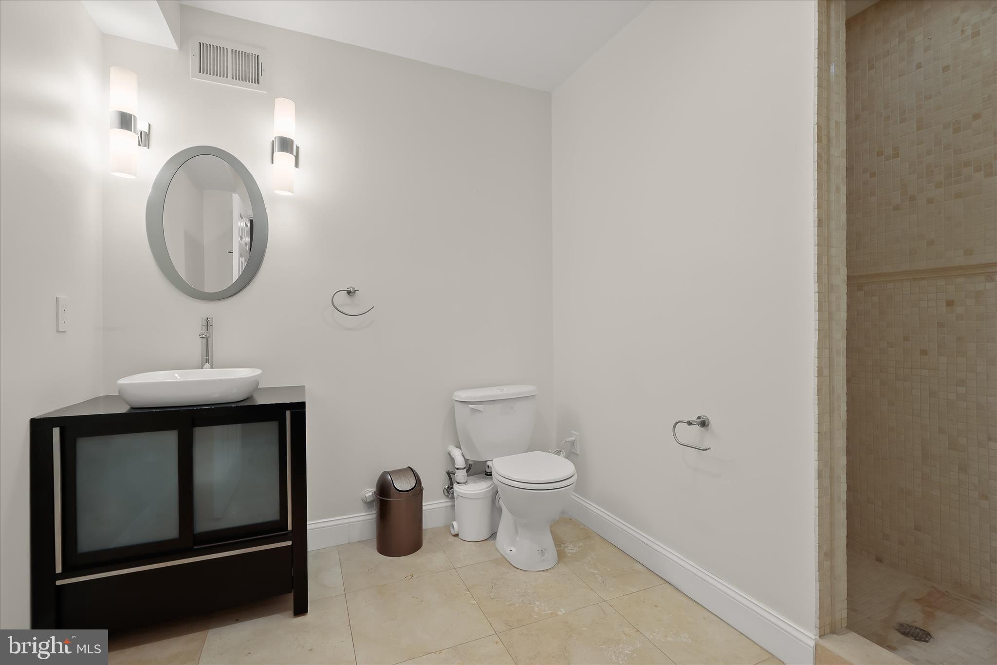515 Garrison Forest Road Owings Mills, MD 21117 - Photo 66 of 84 a bathroom with a toilet and a mirror