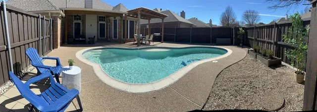 a view of a chair and tables in the patio