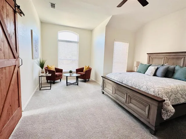 a bed room with a bed and a chandelier