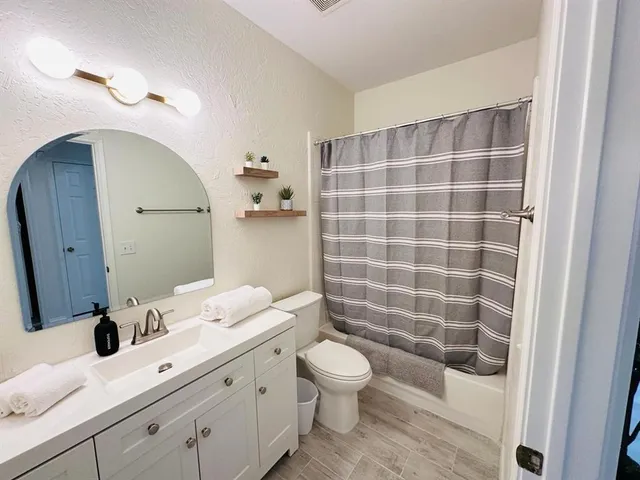 a bedroom with a bed and a ceiling fan