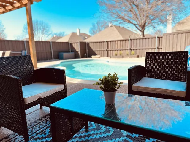 a view of a patio with couches table and chairs and potted plants