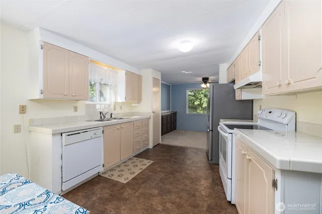 a kitchen with a sink cabinets and window