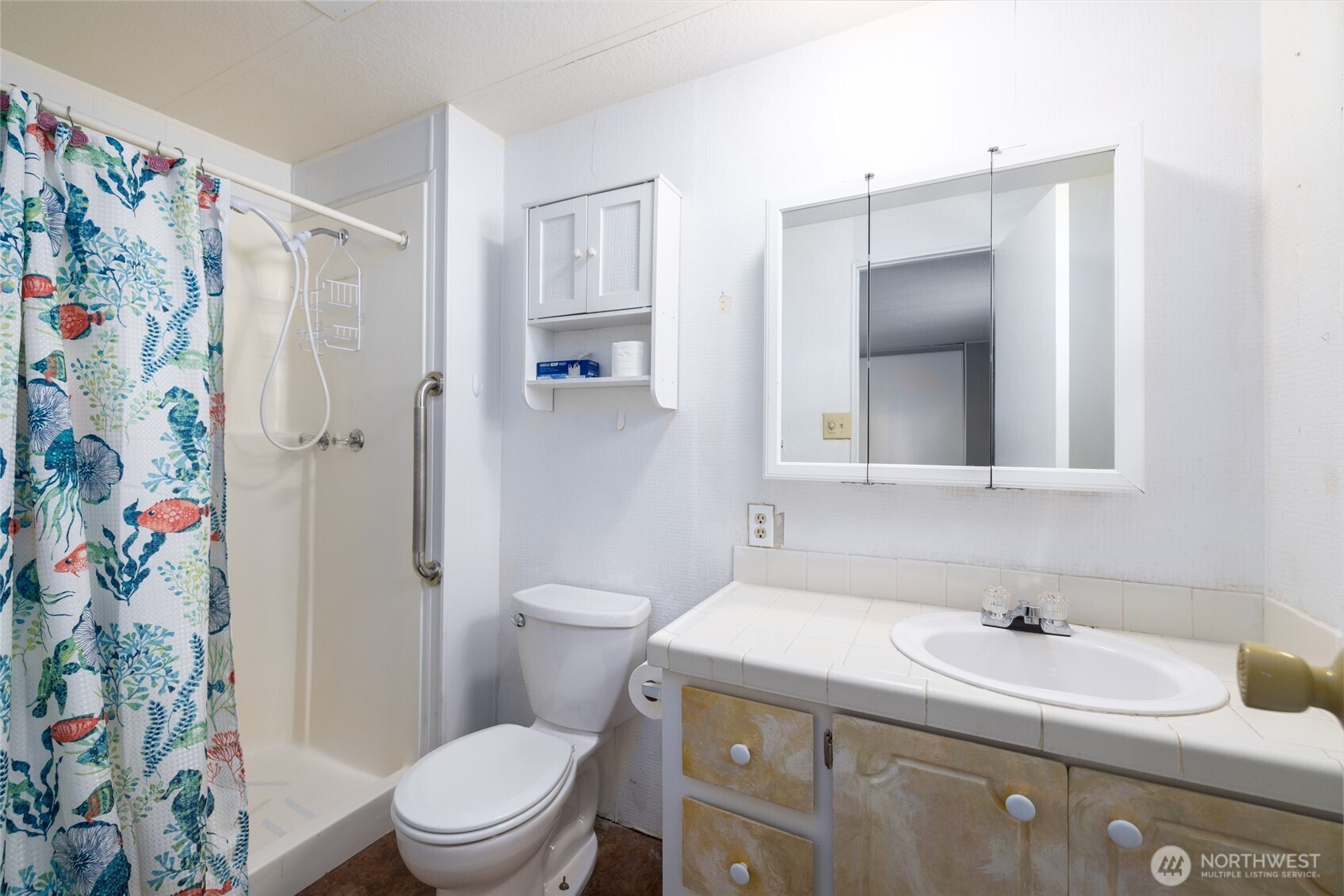 3333 228th Street Southeast, Unit 100 Bothell, WA 98021 - Photo 20 of 27 a bathroom with a sink a toilet and shower curtain