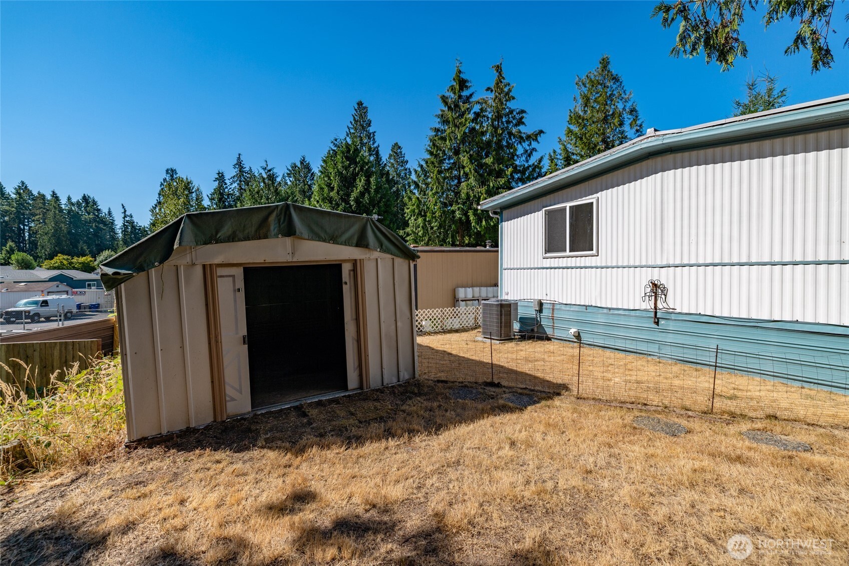3333 228th Street Southeast, Unit 100 Bothell, WA 98021 - Photo 25 of 27 a view of backyard with tub and trees in the background