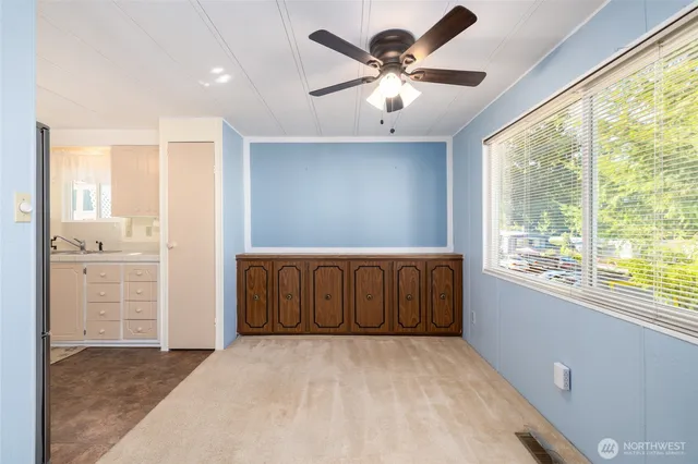 an empty room with windows and cabinet