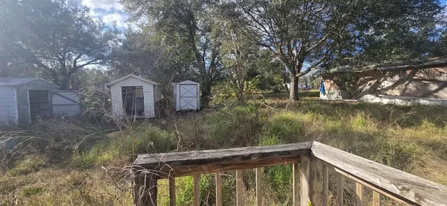 a view of a back yard with a table and chair