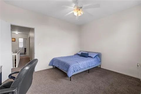 a spacious bedroom with a bed and a chandelier