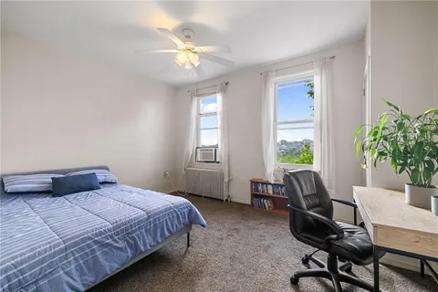 a bedroom with a bed and a desk