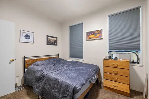 a bedroom with a bed and dresser
