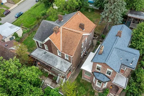 an aerial view of a house with a yard