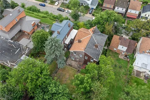 an aerial view of residential house with outdoor space and street view