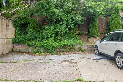 a view of a car parked in a yard
