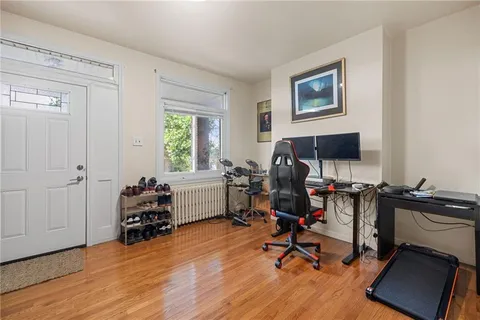 a view of a workspace with furniture and a window