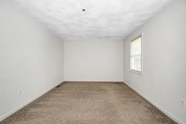 an empty room with a empty space and window