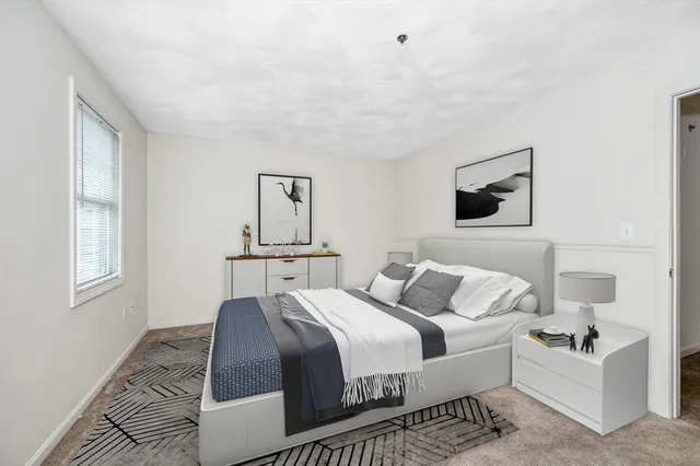 a bedroom with bed and window