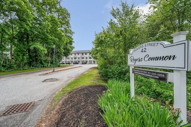 a view of a sign board with garden
