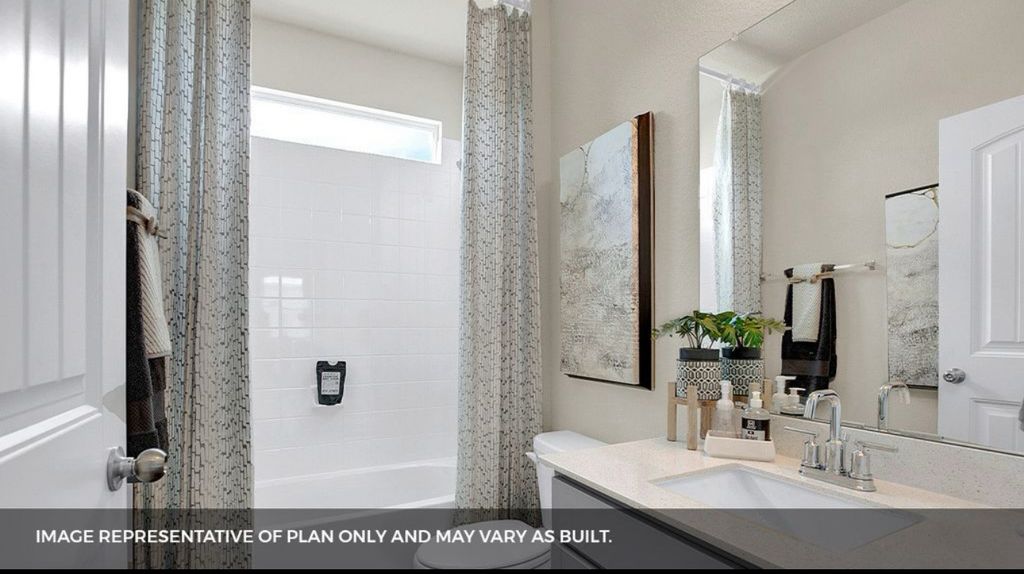 156 Docile Loop San Marcos, TX 78666 - Photo 7 of 40 A well-appointed bath features a bright vanity with ample counter space and a clean, tiled shower.