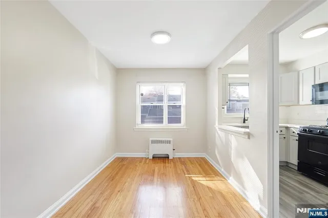 a view of a kitchen with wooden floor and a sink