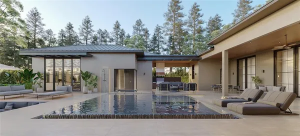 a view of a house with backyard and sitting area