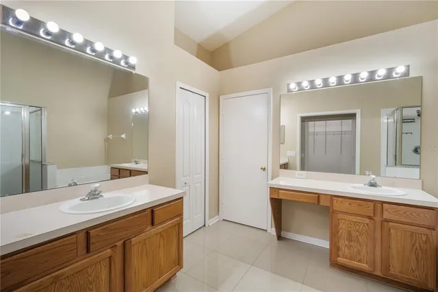 a bathroom with a double vanity sink and a mirror