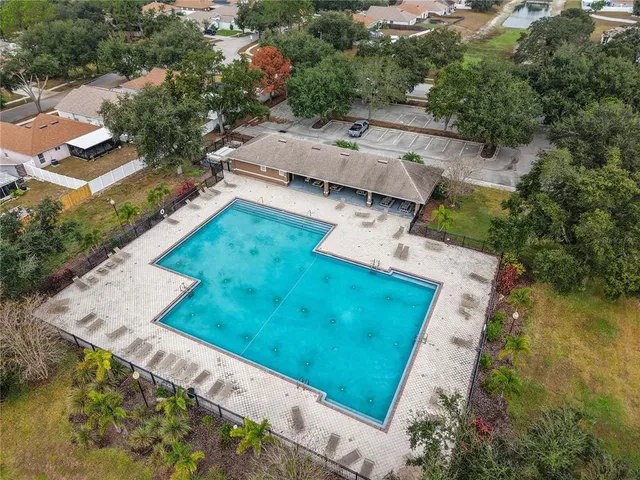 an aerial view of a house with a garden and lake view
