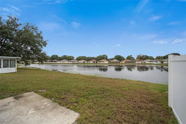 a view of a lake with houses in the background