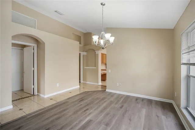 a view of livingroom with chandelier and wooden floor