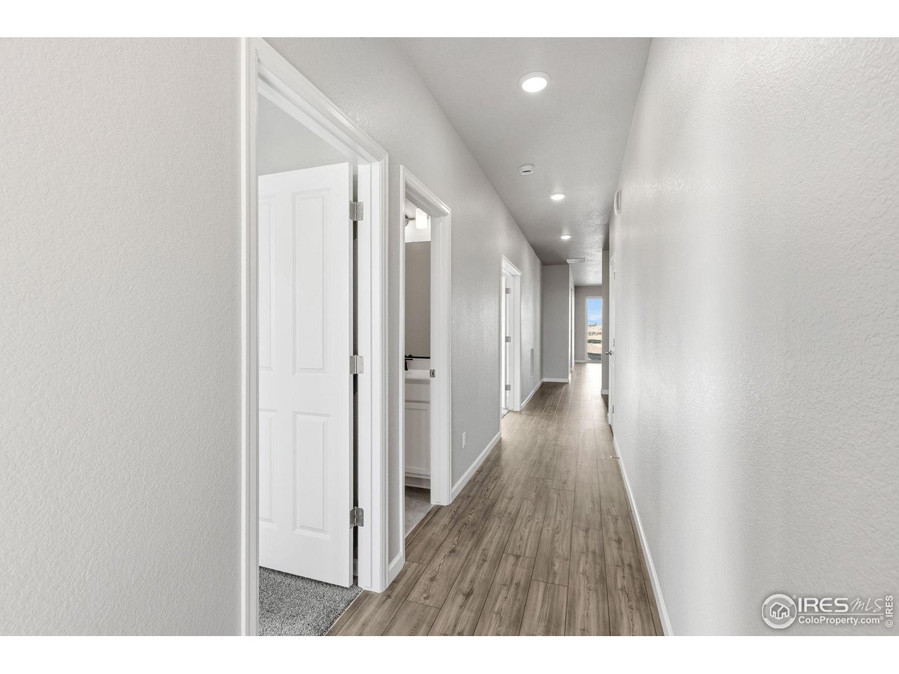 6793 Utica Court Firestone, CO 80504 - Photo 2 of 26 a view of a hallway with wooden floor