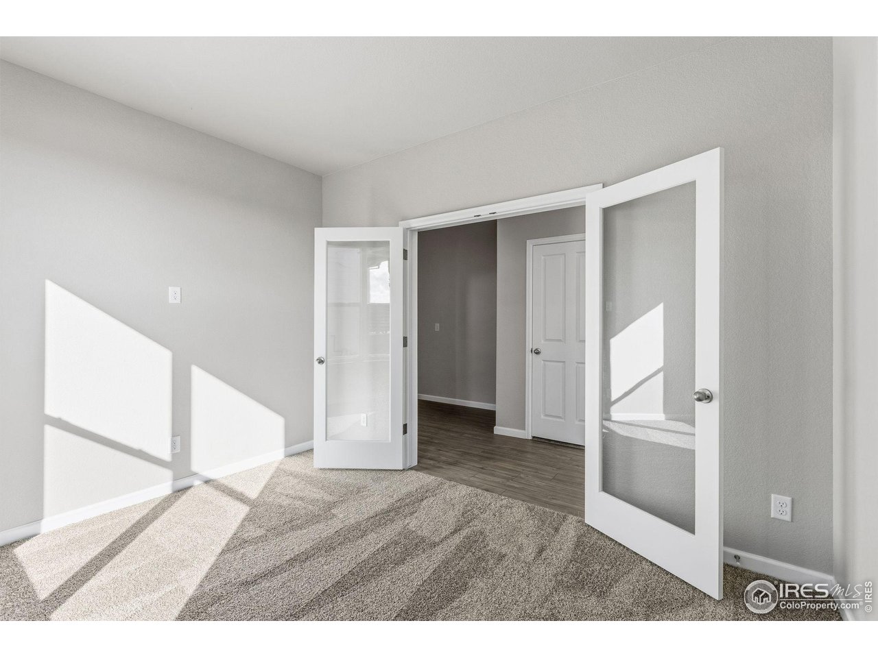 6793 Utica Court Firestone, CO 80504 - Photo 3 of 26 a view interior of a house and an empty room with wooden floor