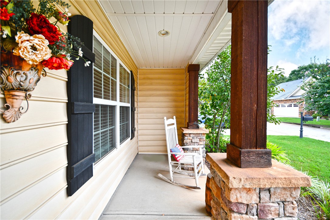 This inviting front porch provides a charming entrance to the home, featuring durable siding and tasteful accents.