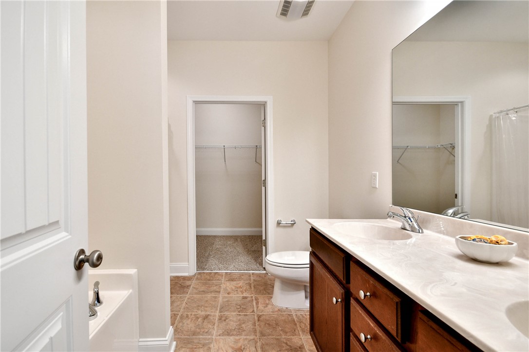 47 Hillsborough Drive Anderson, SC 29621 - Photo 11 of 23 This spacious bathroom offers a double vanity and a walk-in closet for ample storage.