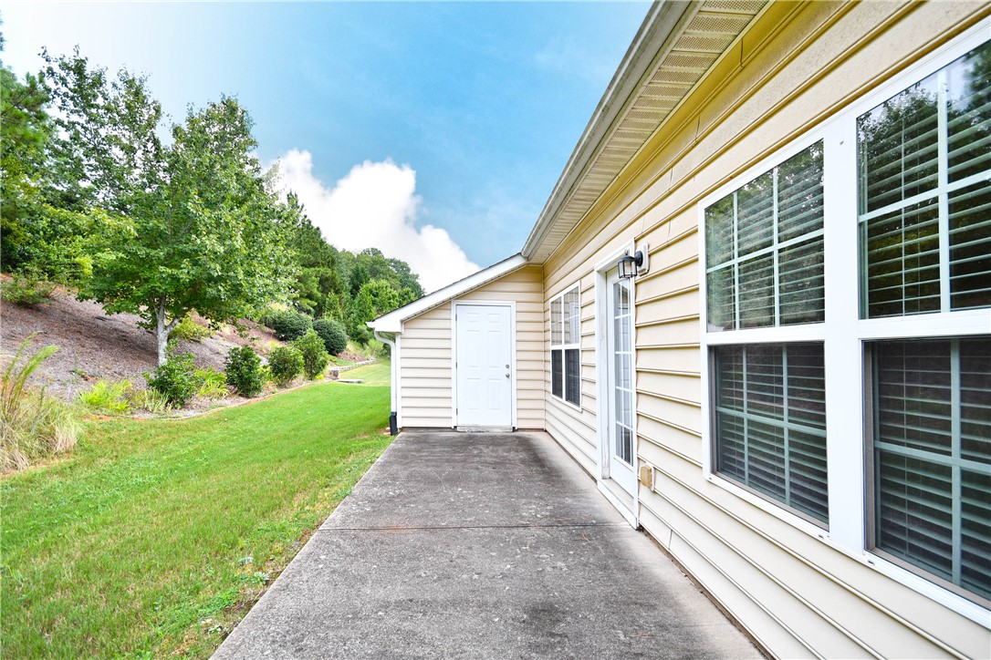47 Hillsborough Drive Anderson, SC 29621 - Photo 21 of 23 This exterior view showcases a well-maintained patio area adjacent to the home's siding.