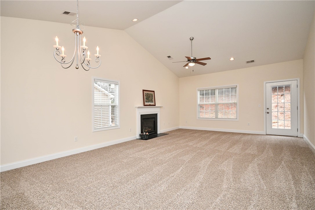 47 Hillsborough Drive Anderson, SC 29621 - Photo 4 of 23 This expansive living space features a fireplace, vaulted ceilings, and natural light.