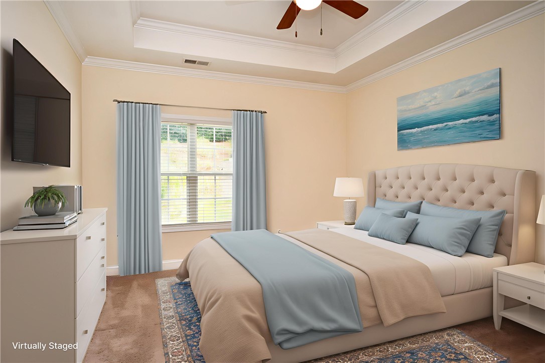 47 Hillsborough Drive Anderson, SC 29621 - Photo 7 of 23 This primary bedroom features crown molding and a tray ceiling, creating an inviting and serene retreat.