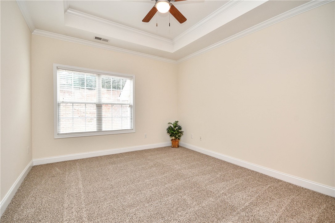 47 Hillsborough Drive Anderson, SC 29621 - Photo 8 of 23 This spacious room features elegant tray ceilings and plush carpeting, creating a comfortable living space.
