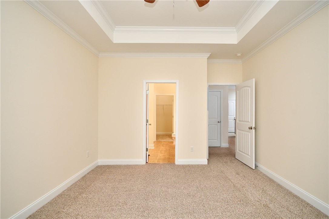 47 Hillsborough Drive Anderson, SC 29621 - Photo 9 of 23 This inviting bedroom features soft carpeting and elegant tray ceilings, creating a tranquil retreat.