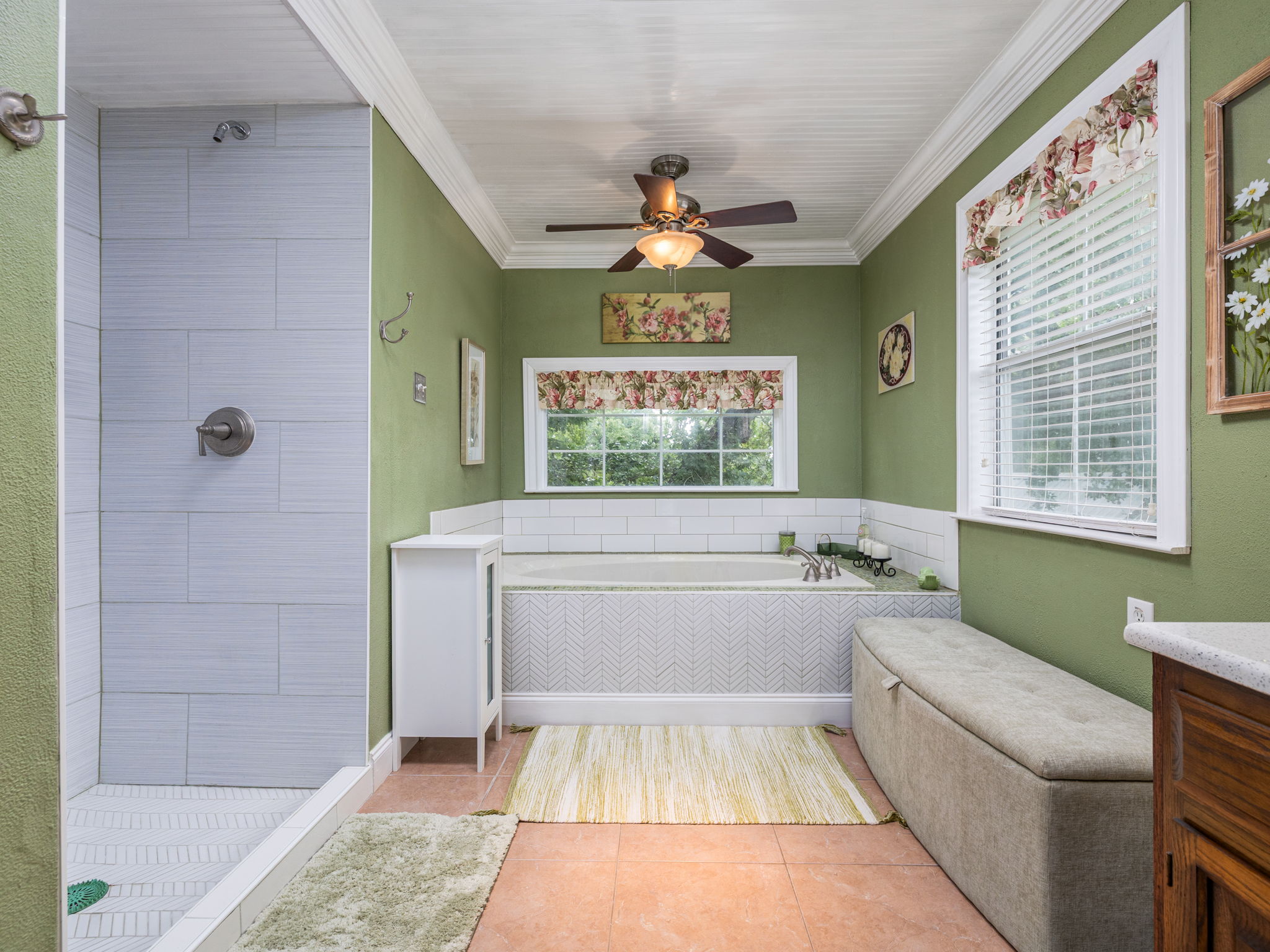 1065 Private Road 7041 Elgin, TX 78621 - Photo 17 of 38 Warm and inviting bathroom featuring elegant crown molding, a separate tiled walk-in shower, and a large garden tub perfect for soaking. Additional highlights include a ceiling fan and durable tile flooring, combining comfort with style