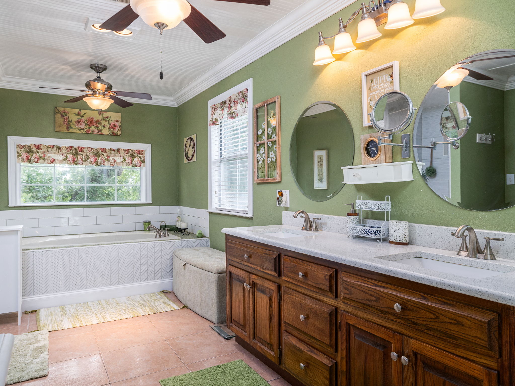 1065 Private Road 7041 Elgin, TX 78621 - Photo 18 of 38 Full bath featuring elegant crown molding, dual vanities, and double ceiling fans for added comfort. The ornate, detailed ceiling complements a large garden tub perfect for soaking. Also includes a spacious walk-in closet with its own ceiling fan (not pictured).