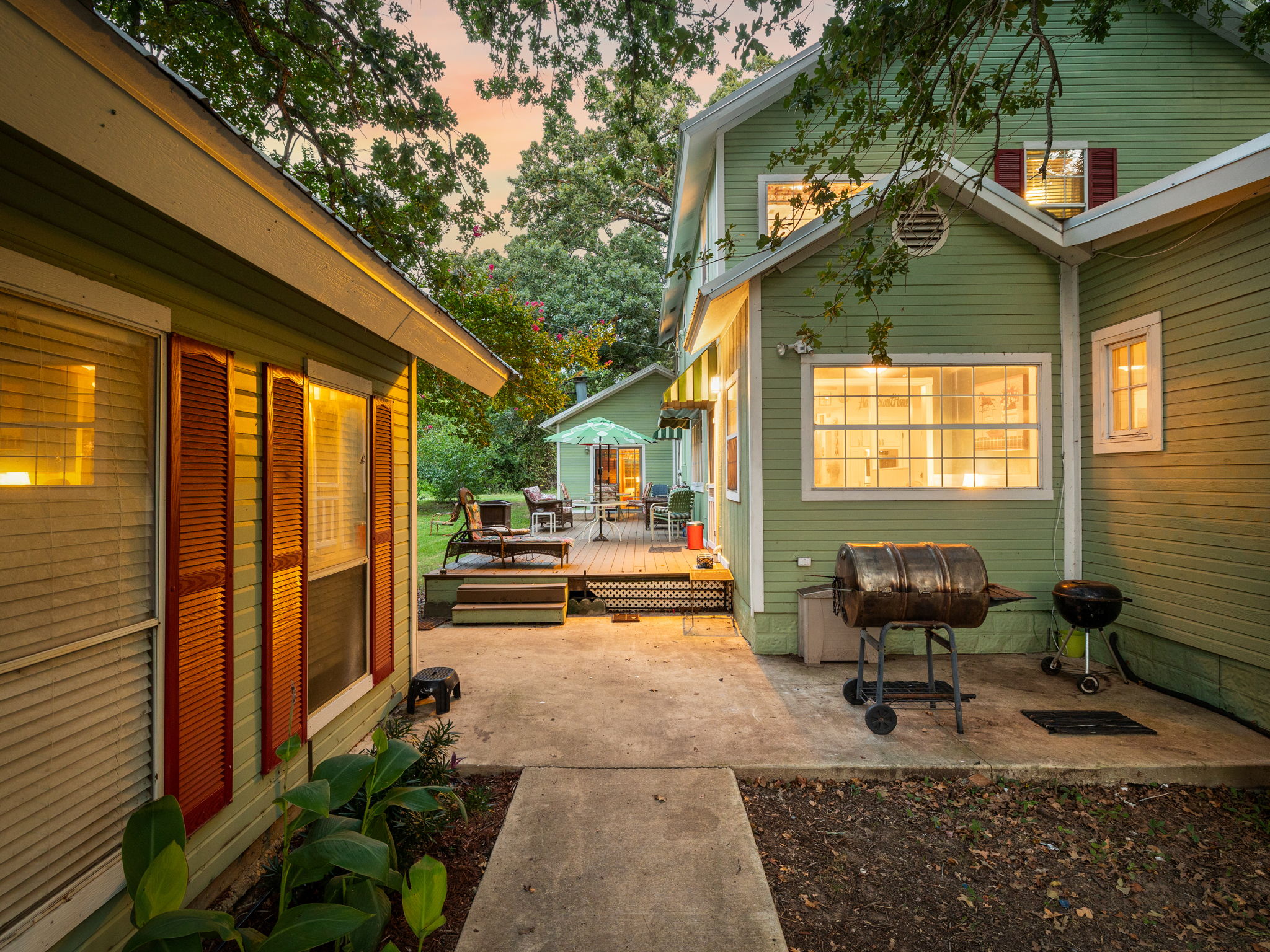 1065 Private Road 7041 Elgin, TX 78621 - Photo 25 of 38 Patio terrace at dusk showcasing the inviting deck and patio area, perfect for relaxing or entertaining as the day winds down