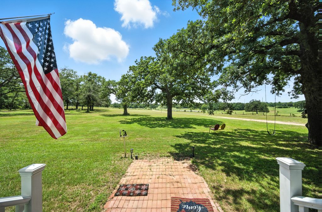 1065 Private Road 7041 Elgin, TX 78621 - Photo 29 of 38 View of front towards the driveway, Big mature trees, plenty of open space and shade