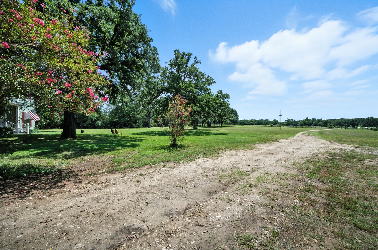 1065 Private Road 7041 Elgin, TX 78621 - Photo 33 of 38 Side view of the front yard Beautiful trees, large yard, lots of shade