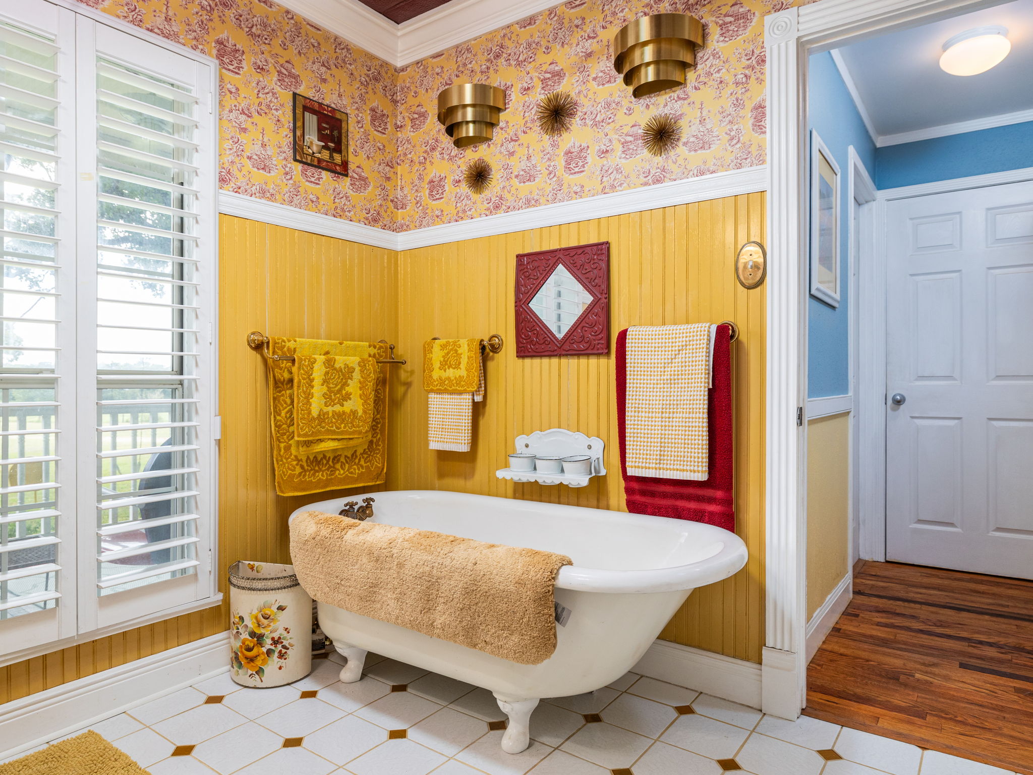 1065 Private Road 7041 Elgin, TX 78621 - Photo 5 of 38 Full bathroom featuring elegant crown molding, an antique clawfoot soaking tub, and beautifully detailed wallpapered walls with intricate trim. A timeless blend of charm and character.