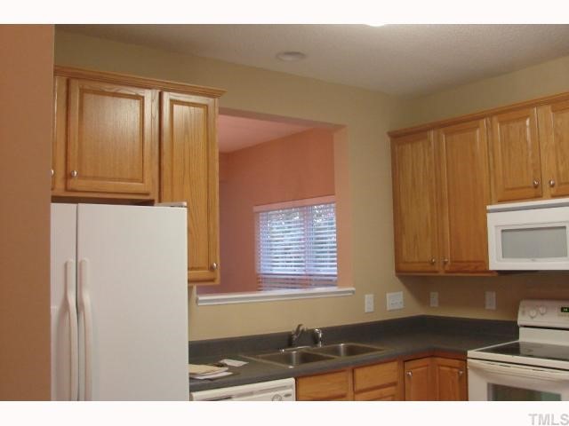 107 Galimore Way Apex, NC 27502 - Photo 2 of 12 a kitchen with a window and cabinets