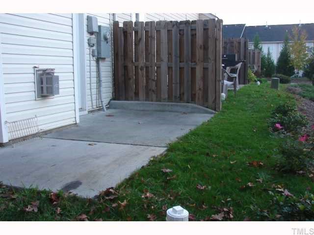 107 Galimore Way Apex, NC 27502 - Photo 7 of 12 a view of a backyard with wooden fence