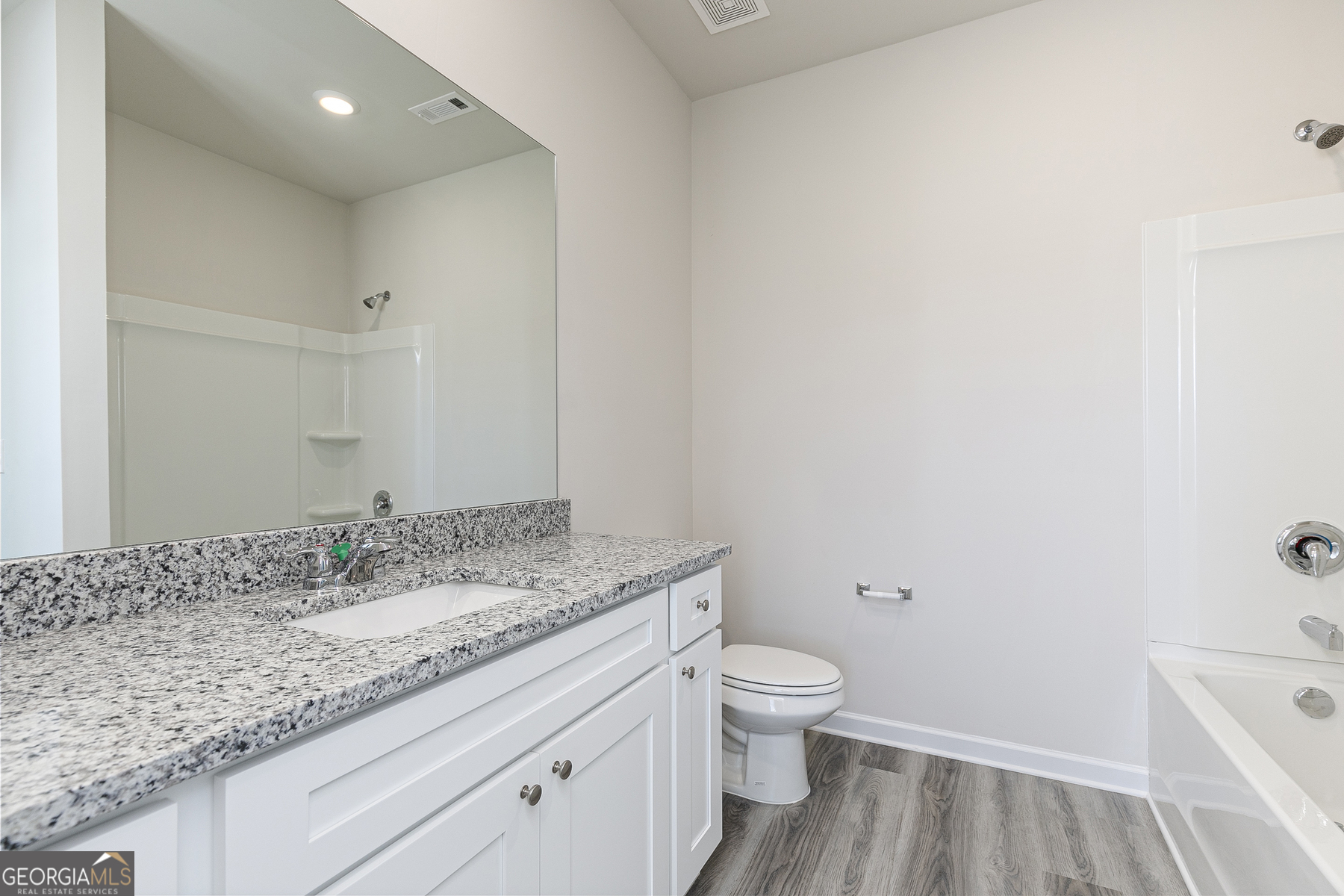 228 Rooker Drive LaGrange, GA 30241 - Photo 14 of 17 a bathroom with a granite countertop sink a toilet and a bathtub