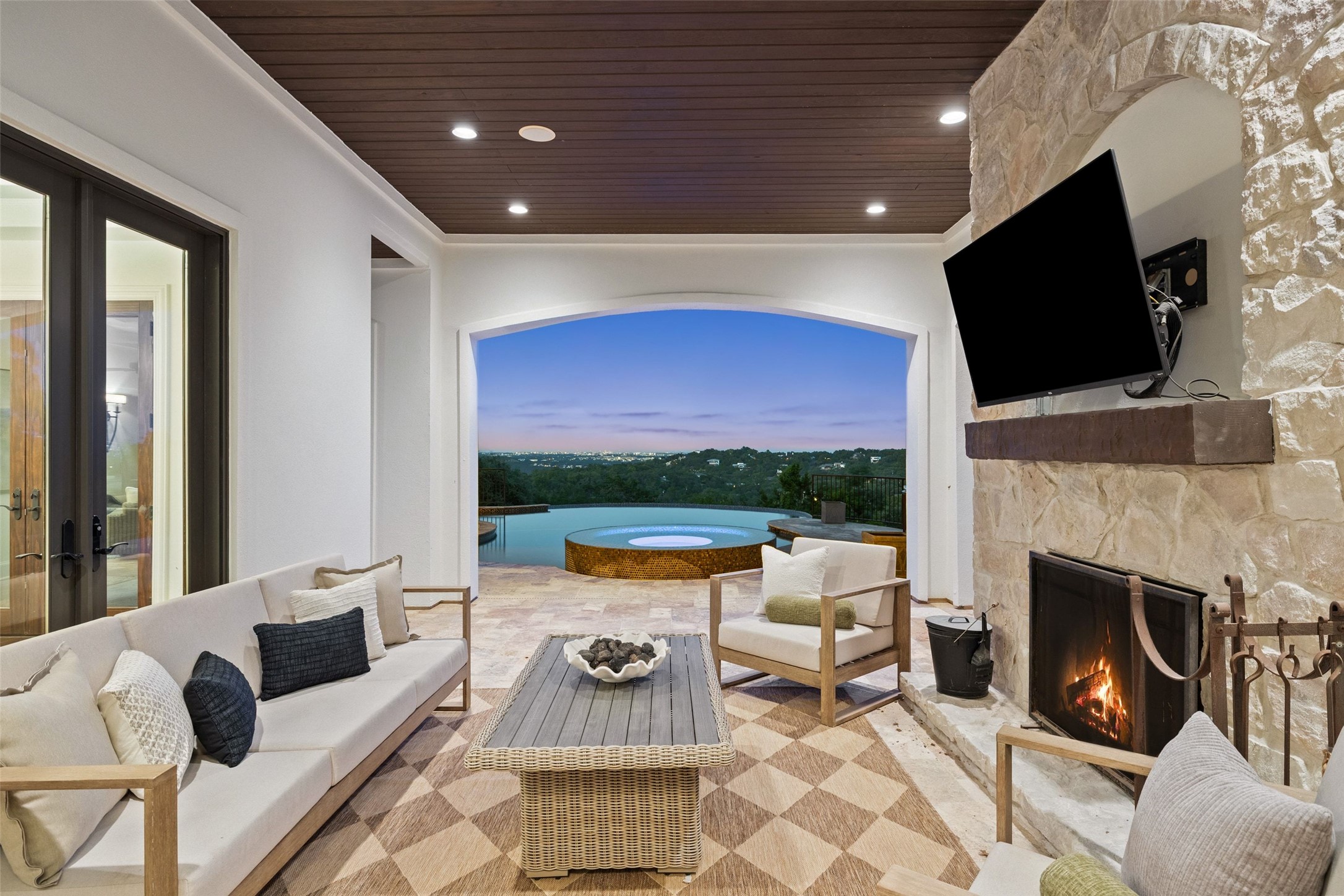 1414 The High Road Austin, TX 78746 - Photo 31 of 40 An inviting outdoor living space with a fireplace and unparalleled views of the landscape.